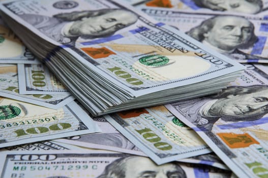 Cash hundred dollar bills, dollar background image. A stack and roll of one hundred American bills