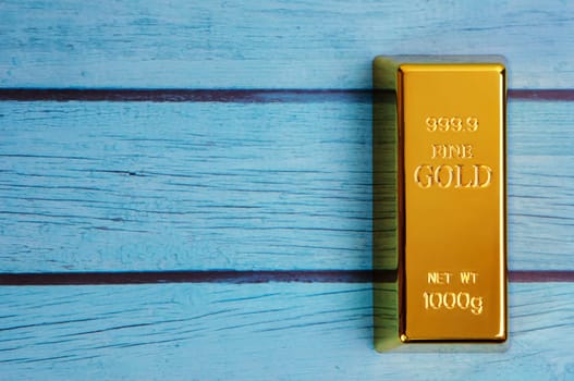 An ingot of gold metal made of pure diamond, located diagonally on a blue textured background