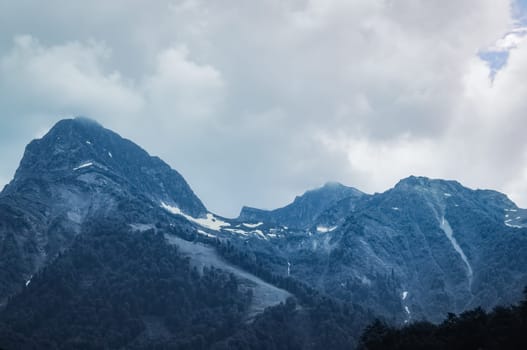 Mountain landscape. Snowy peak. Fog and aerial perspective