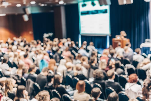 Blured image of audience in conference hall attending business conference. Business and Entrepreneurship concept.
