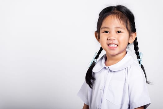 Asian adorable toddler smiling happy wearing student thai uniform red skirt standing in studio shot isolated on white background, Portrait little children girl preschool, Happy child Back to school