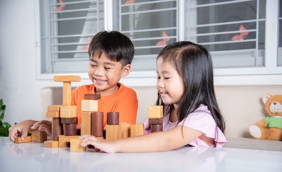 Happy little kids play wood block stacking board game at home, Children boy and girl playing with constructor wooden block, childhood activities learning creative, toys for preschool and kindergarten