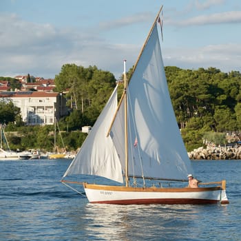Sailboat in front of the town of Krk on the island of the same name on the Adriatic Sea in Croatia