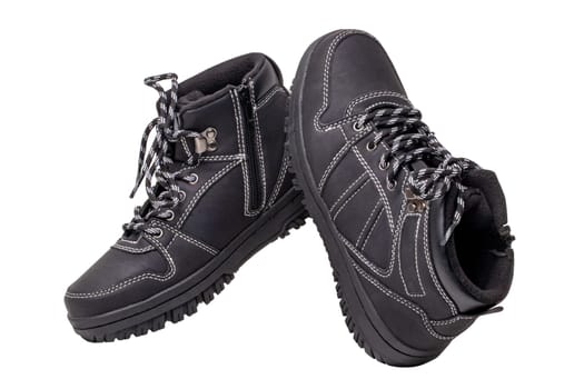 Winter boots. Close-up of a pair elegant black leather winter boots with laces and rivets isolated on white. Clipping path. Macro. Autumn shoe fashion for child boy.