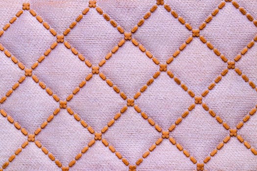 Polyester background texture. Close-up of colorful pink yellow synthetic fiber pattern for textile, shoes, bags  or other garments. Macro.
