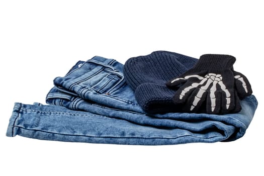 Halloween equipment. Close-up of a jeans, a blue knitted hat or cap and a pair of skeleton gloves isolated on a white background. Clipping path.