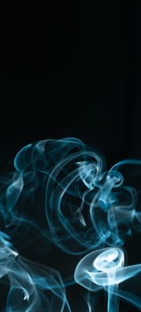 Creative background partially blurred image, vertical dark blue banner with puffs of neon blue white smoke. Copy space. Place for text