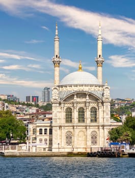 View from Bosphorus Strait overlooking Ortakoy Mosque, or Ortakoy Camii, aka Buyuk Mecidiye Camii, suited at the waterside of the Ortakoy pier square, Istanbul, Turkey