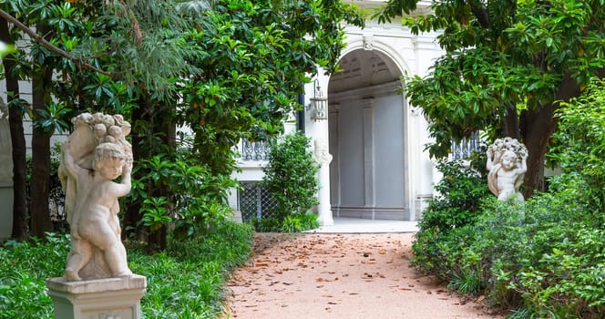 Milan, Italy - Circa June 2021: Italian Villa entrance with garden. Luxurious green exterior