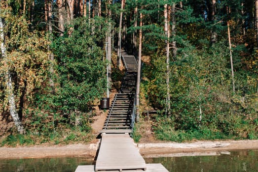 Wooden staircase descending to a wooden pier on Lake Baltieji Lakajai in Labanoras Regional Park, Lithuania.