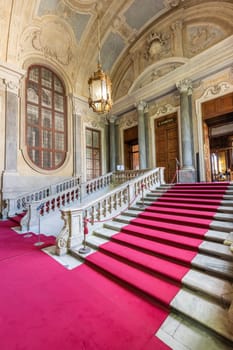 Turin, Italy - Circa August 2021: marble staircase in historic palace with luxury interior - Savoia Royal Palace