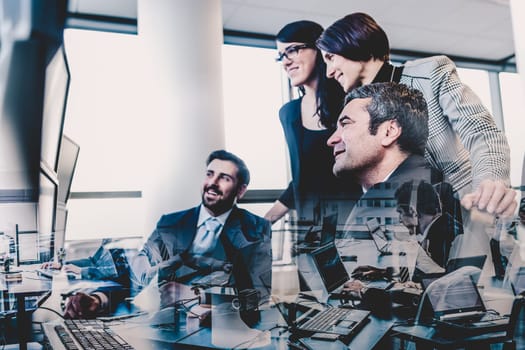 Business team looking at data on multiple computer screens in corporate office. Business people trading online. Business, entrepreneurship and team work concept.