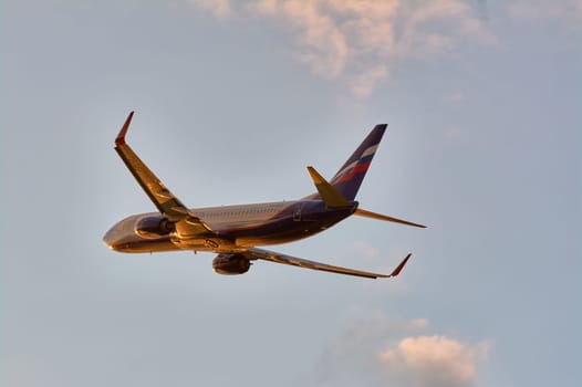 The Boeing plane flies against the background of a blue sky with clouds. Talagi Airport, Arkhangelsk, Russia, 27,08,2022. High quality photo