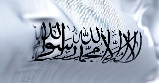 The flag of the Islamic Emirate of Afghanistan waving in the wind. It is an unrecognized Islamic emirate that was established by taliban in August 2021 with the fall of Kabul