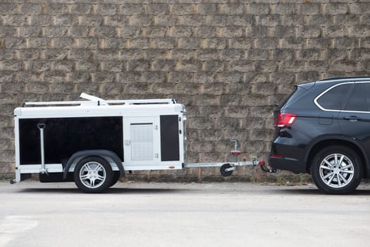 Parked travel dog trailer. All-road vehicule hooked