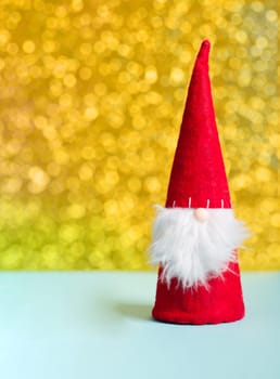 Gnome with golden bokeh fairy lights, christmas holiday greeting card, winter season