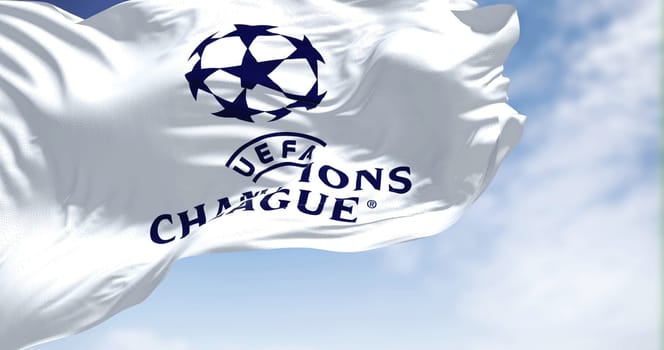 Istanbul TUR, July 2022: The UEFA Champions league flag waving on a clear day. Champion League is the most prestigious club competition in European football. Fabric textured background.