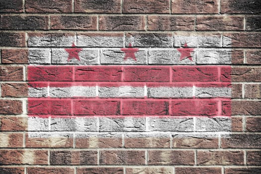 A Washington DC flag on a brick wall background