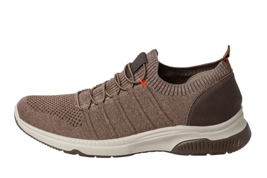 Closeup of a single of modern brown sneaker or sports shoe isolated on a white background. Clipping path. Elegant and trendy mans shoe. Macro.