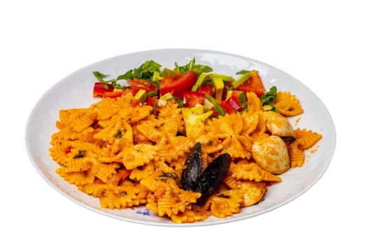 Mussel pasta with vegetable, pepper and parsley on a plate isolated on a white background. Clipping path. Macro. Healthy food.