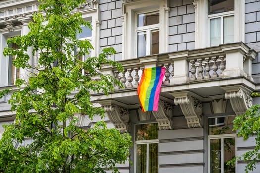 Rainbow LGBT flag hanging on the balcony of a residential building in Vilnius