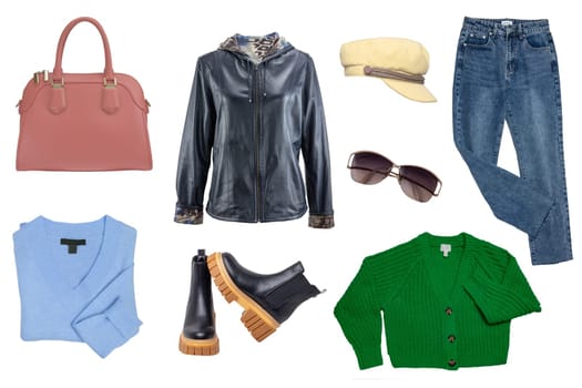 Collage woman clothing. Set of a stylish and trendy leather jacket, boots, jeans, shirt and cardigan, handbag and other accessories isolated on a white background. Latest fashion trends.