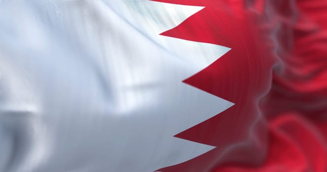 Close-up view of the Bahrain national flag waving in the wind. The Kingdom of Bahrain is an island country in Western Asia. Fabric textured background. Selective focus