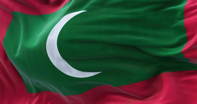 Close-up view of the Maldives national flag waving. The Republic of Maldives is an archipelagic state located in South Asia. Fabric textured background. Selective focus