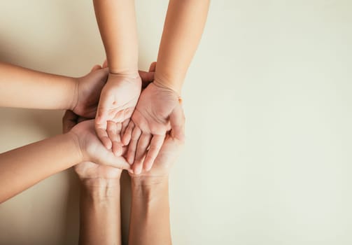 Closeup top view family hands stack palms studio shot isolated on pastel background, parents and kid holding empty free space on hand together, Gesture sign of support and love, Family and parents day