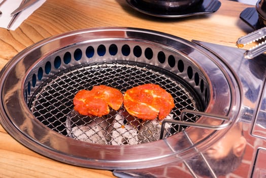 Korean beef barbecue on hot coals. Grill meat pork Korean BBQ traditional style on stove serve in restaurant, Japanese food