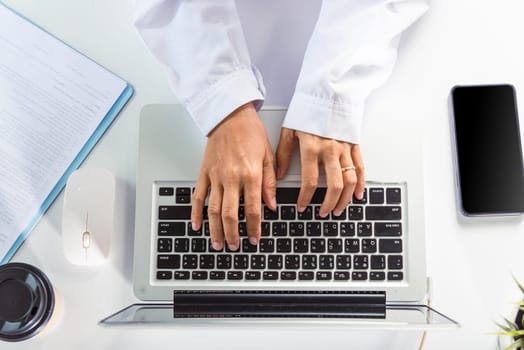 Hands of female doctor wear uniform in hospital she typing information on keyboard laptop, nurse working using computer browsing internet, Healthcare medical health website technology online data