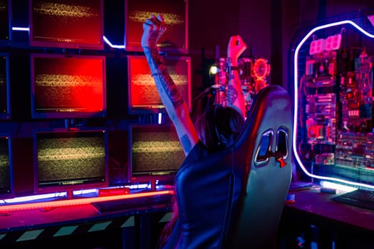 Winner. Happy young gamer plays online video games computer she raises hands to wins tournament, young woman people in gaming headphones playing video game online at home feel excited, E-Sport concept