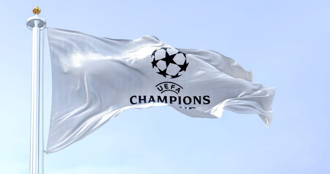 Istanbul TUR, July 2022: The UEFA Champions league flag waving on a clear day. Champion League is the most prestigious club competition in European football. Fabric textured background.
