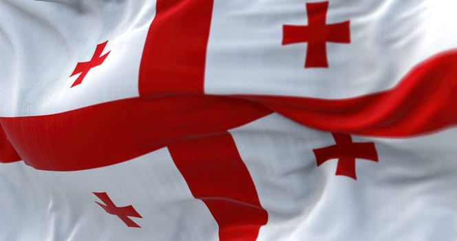 Close-up view of the Georgian national flag waving in the wind. Georgia is a country at the intersection of Eastern Europe and Western Asia. Fabric textured background. Selective focus