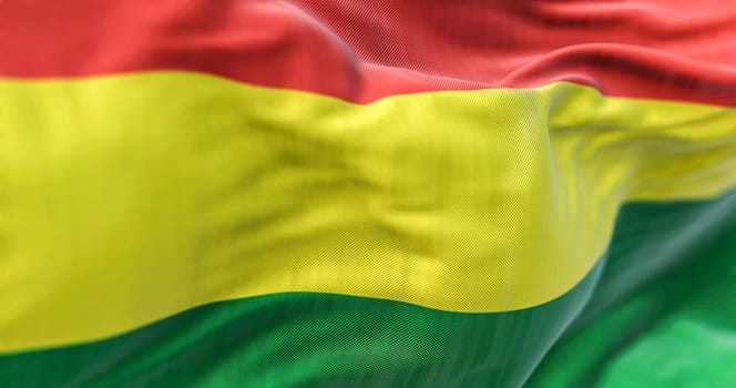Close-up view of the Bolivia national flag waving in the wind. The Plurinational State of Bolivia is a State of South America. Fabric textured background. Selective focus