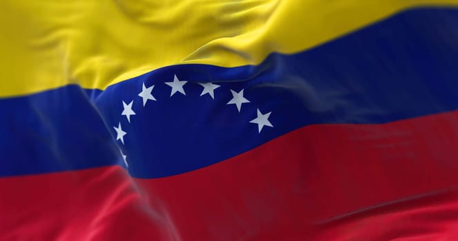 Close-up view of Venezuela national flag waving in the wind. The Bolivarian Republic of Venezuela is a state located in North South America. Fabric textured background. Selective focus