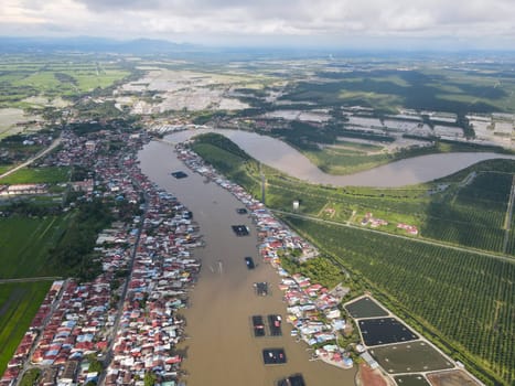 Aerial view curve Sungai Kurau pass fishing village to sea.