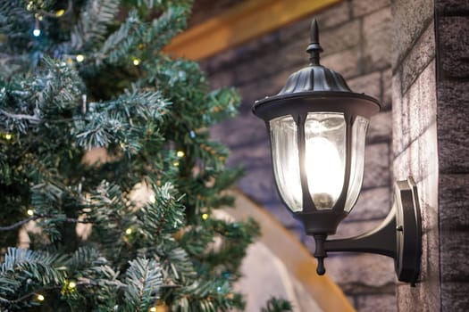 Lamp beside Christmas tree decoration. Christmas, winter holiday concept