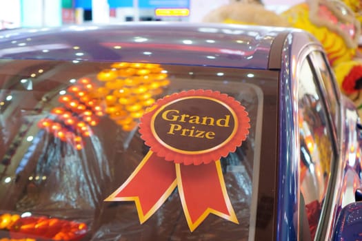 Select focus grand prize gift of car with red lantern decoration reflect in windows