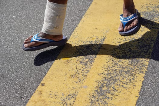Select focus the wound foot walk at street asphalt road