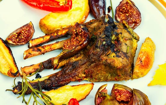 Lamb meat on the ribs, roasted with figs. Grilled lamb ribs