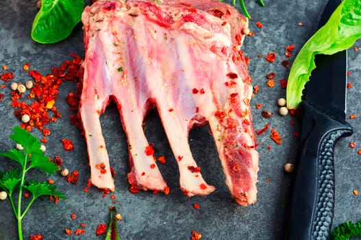 Appetizing raw lamb rib and spices on the kitchen table