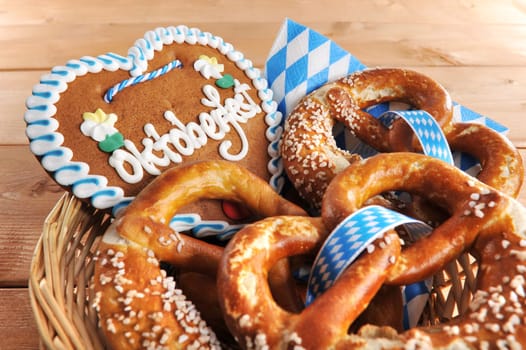 original Bavarian lye pretzels with gingerbread heart in a basket on wooden boards