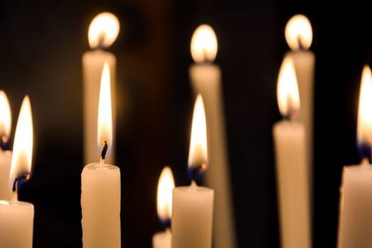 candles burning in the dark of a church