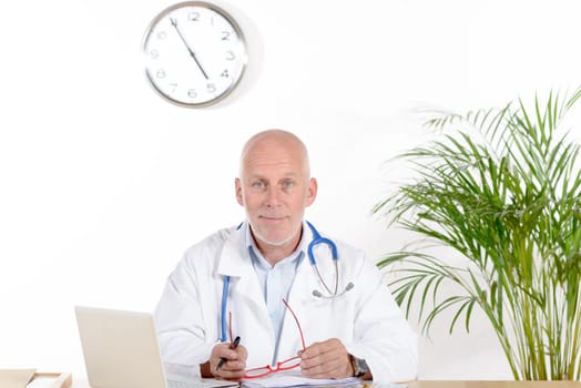 a doctor in his office with red glasses