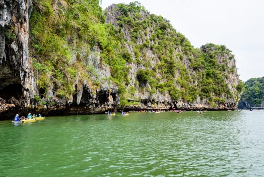 PHANG NGA, THAILAND - APRIL 27 2015: Tourists are happy with the canoeing near island on the sea surface at Tham Lod cave in Ao Phang Nga Bay National Park, APRIL 27 2015 in Thailand