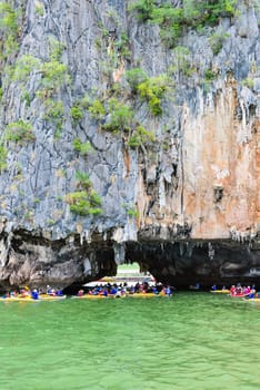 PHANG NGA, THAILAND - APRIL 27 2015: Tourists are happy with the canoeing near island on the sea surface at Tham Lod cave in Ao Phang Nga Bay National Park, APRIL 27 2015 in Thailand