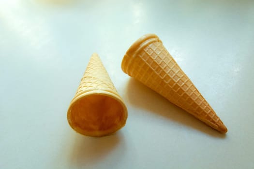 Empty cripsy wafers for ice cream on a white countertop