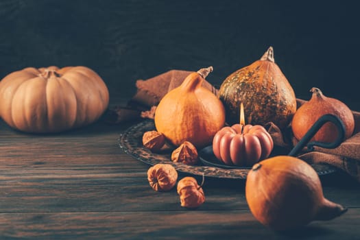 Happy Thanksgiving Day background, wooden table decorated with Pumpkins and Candles