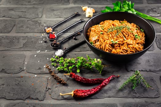 Mince. Marinated Ground meat with ingredients for cooking on black background.
